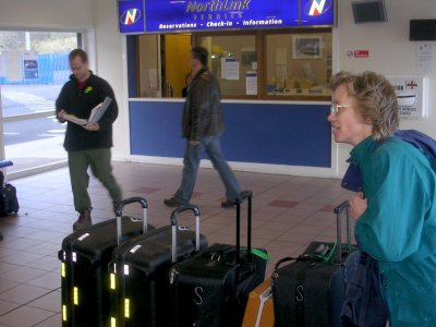 Terry with luggage at bus transfer station.